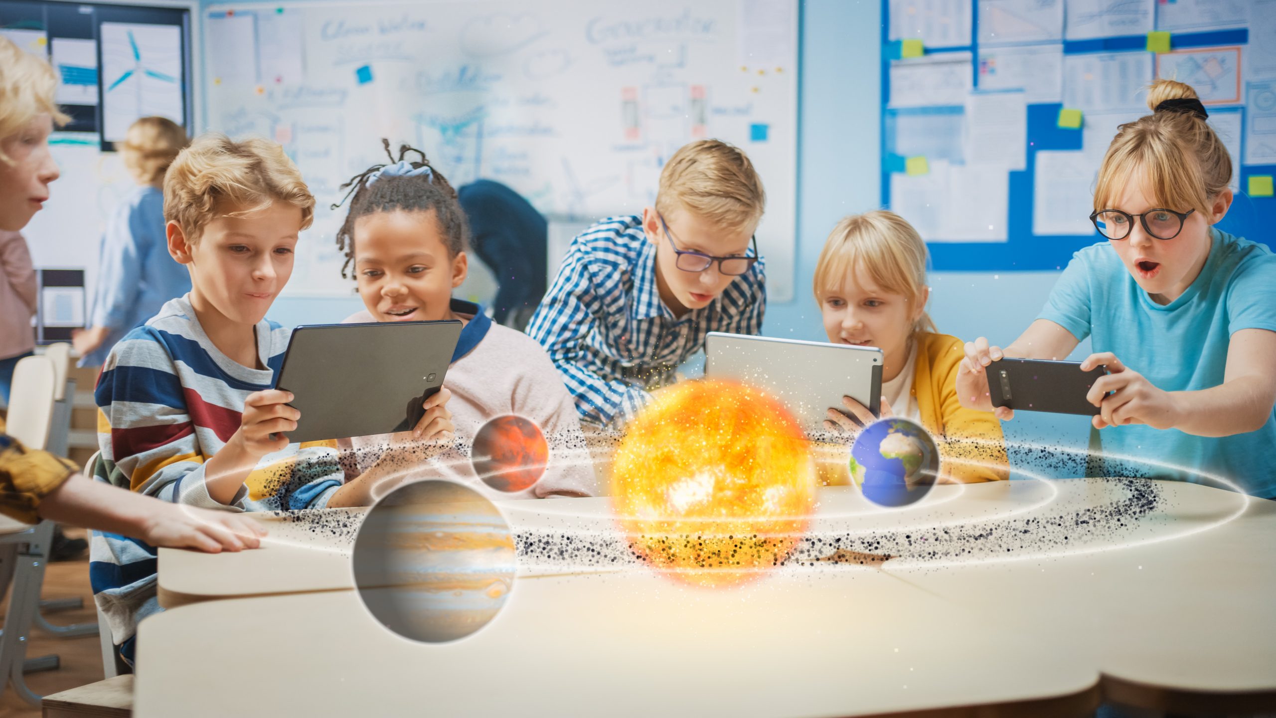 Group of School Children in Science Class Use Digital Tablet Computers with Augmented Reality Software, Looking at Educational 3D Animation Of Solar System. VFX, Special Effects Render